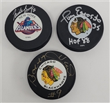 Lot of 3 Bobby Hull, Tony Esposito, & Mike Bossy Autographed Hockey Pucks Beckett