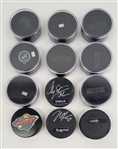 Lot of 12 Minnesota Wild Autographed Hockey Pucks